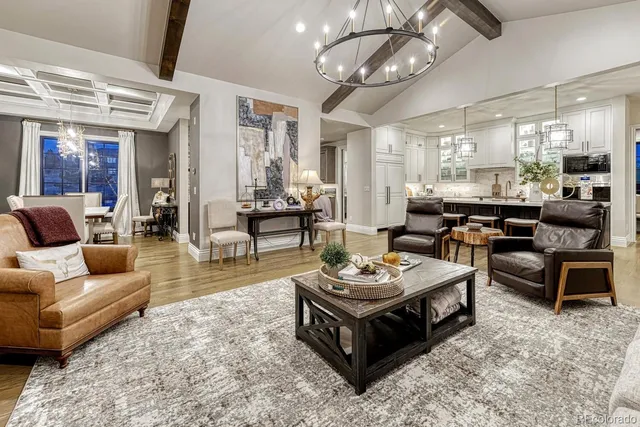 a living room with furniture a rug and a chandelier