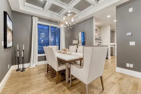 a view of a dining room with furniture and chandelier