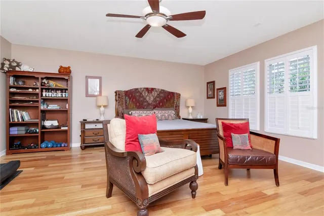 a living room with furniture and a book shelf