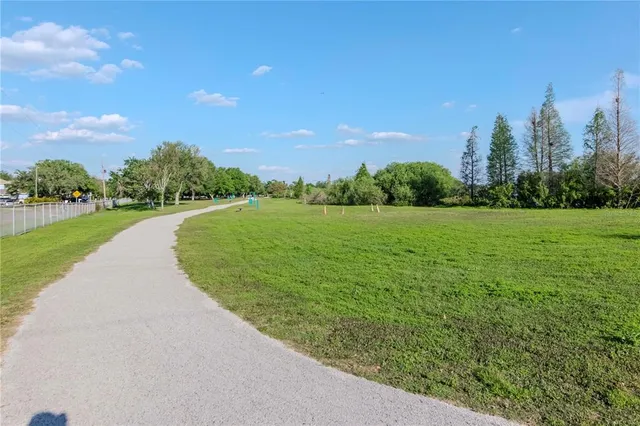 a view of a garden with a building in the background