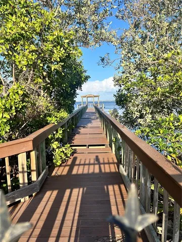 a view of balcony with wooden floor and fence