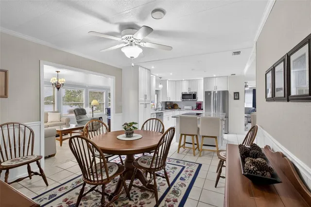 a view of a dining room with furniture and a chandelier