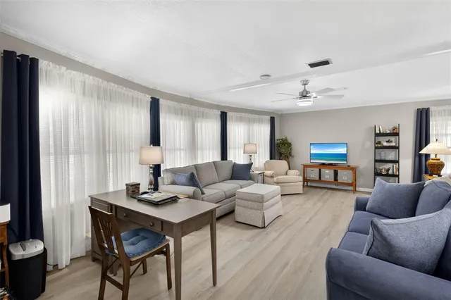 a living room with furniture and wooden floor