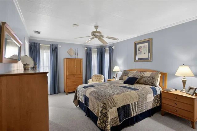 a bedroom with a bed lamps and a window