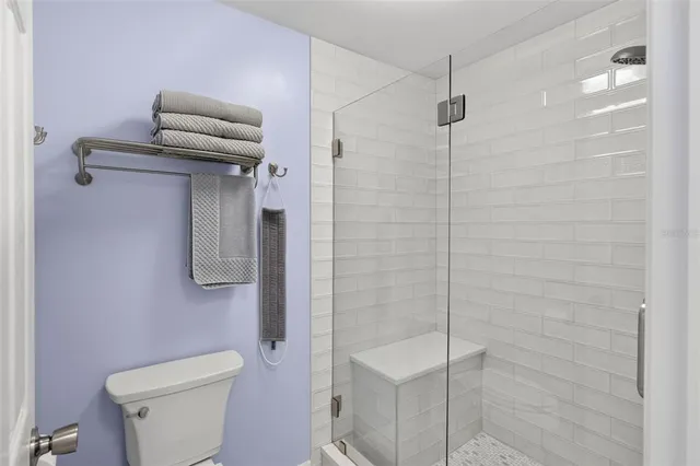 a bathroom with a shower a toilet and a sink