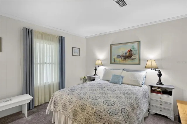 a bedroom with a bed and a painting on the wall