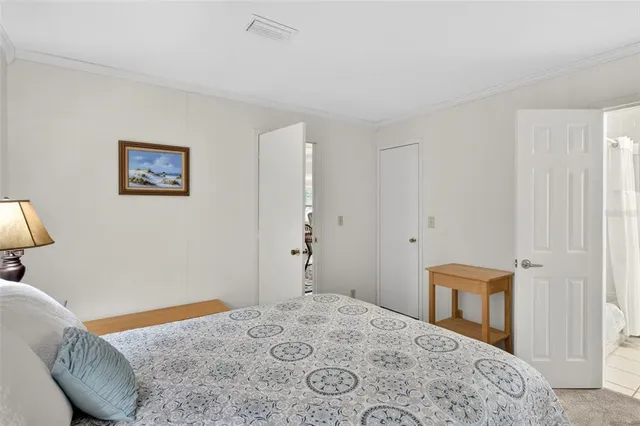 a bedroom with a bed and a lamp