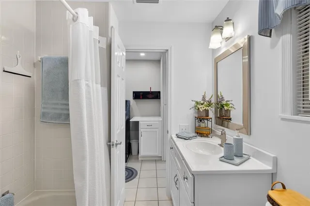 a bathroom with a sink vanity and a mirror