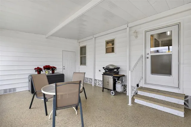 a workspace with furniture a rug and a window