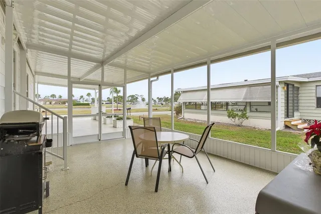 a dining room with furniture and a garden view