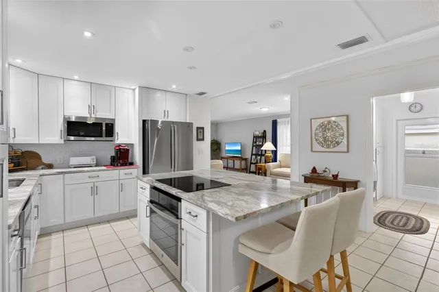 a kitchen with granite countertop appliances cabinets and furniture