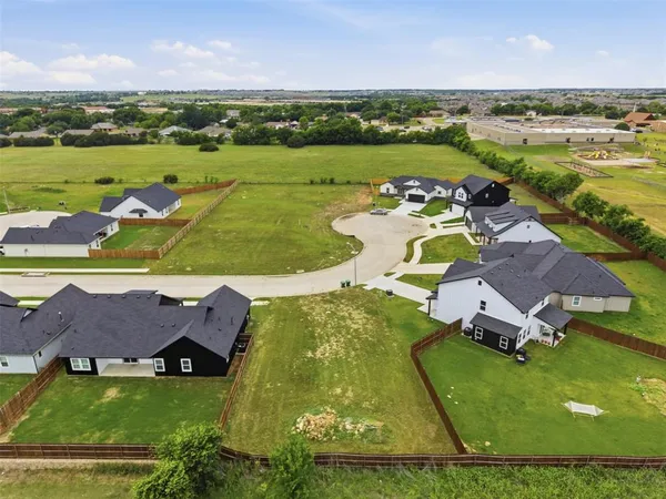 an aerial view of residential houses with outdoor space and river