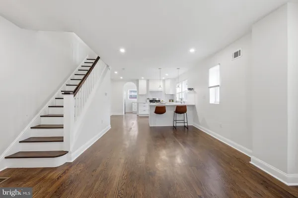 a view of kitchen with wooden floor and electronic appliances