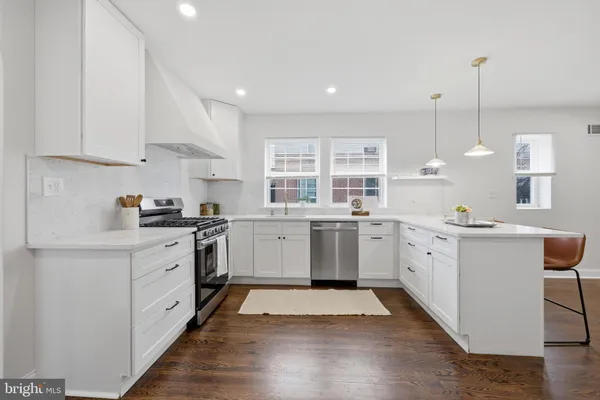 a kitchen with a sink window and cabinets