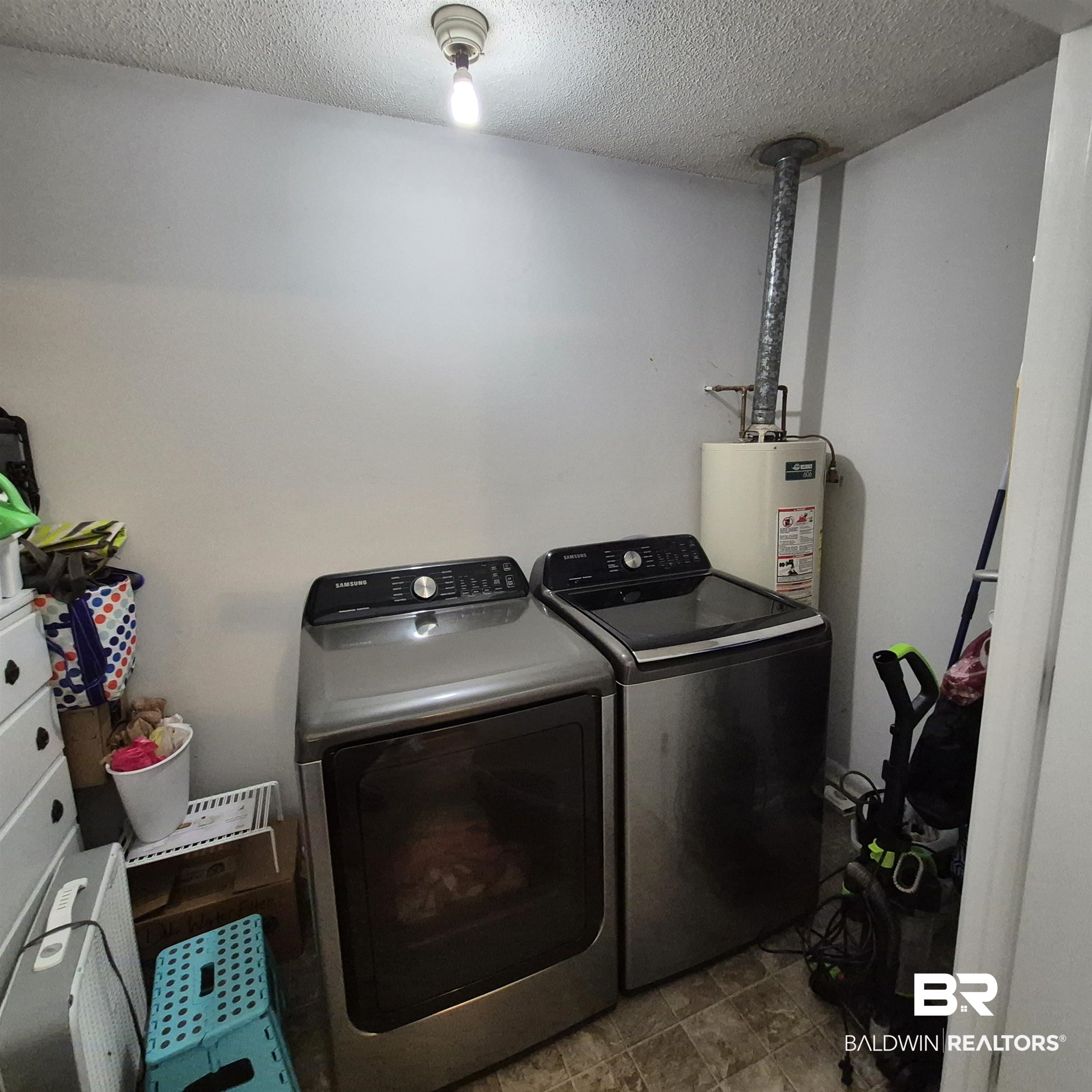 721 Perryman Street Evergreen, AL 36401 - Photo 18 of 26 Laundry area featuring a textured ceiling, independent washer and dryer, and water heater