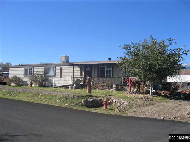 105 Gemini Circle Reno, NV 89521 - Photo 1 of 13 a front view of a house with garden