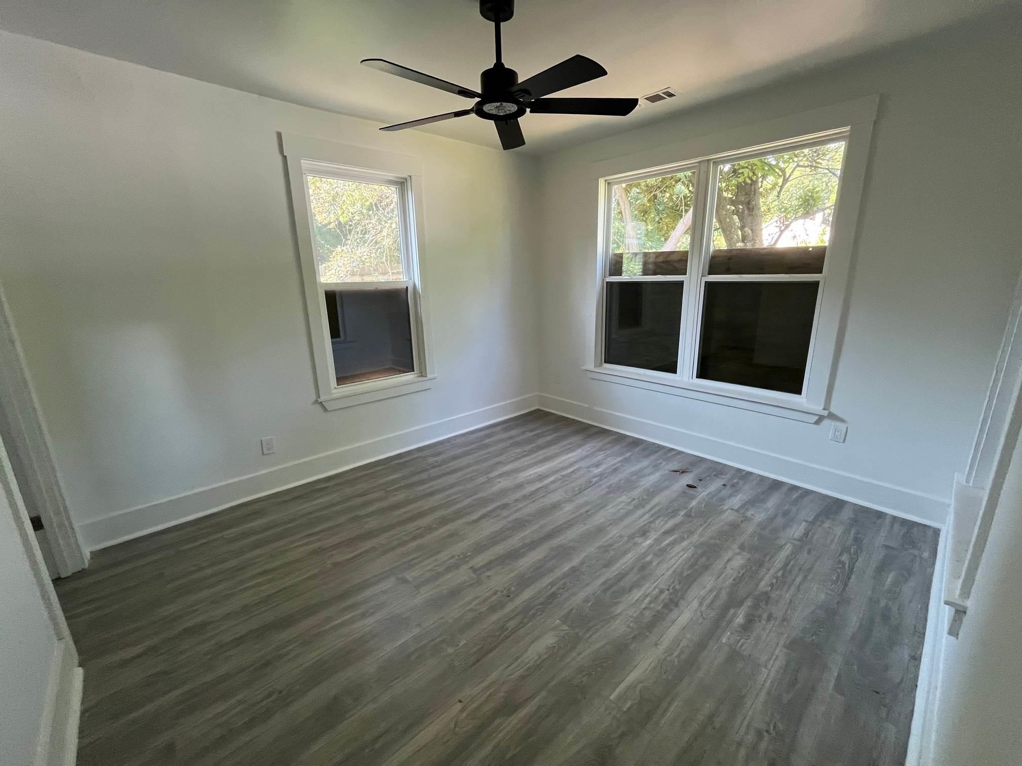 1131 Rozelle Street Memphis, TN 38106 - Photo 11 of 19 an empty room with wooden floor and windows