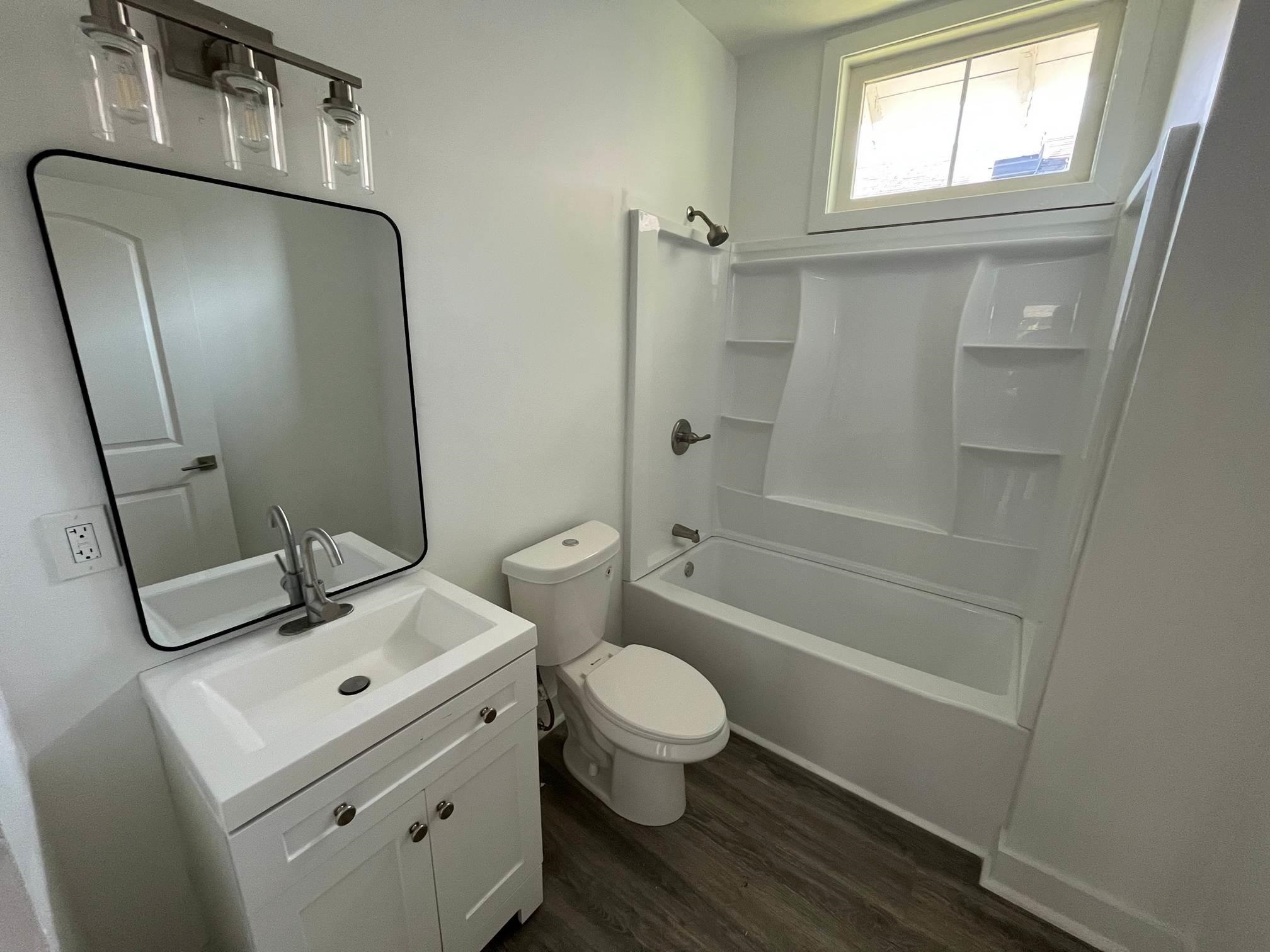 1131 Rozelle Street Memphis, TN 38106 - Photo 16 of 19 a bathroom with a sink toilet and shower