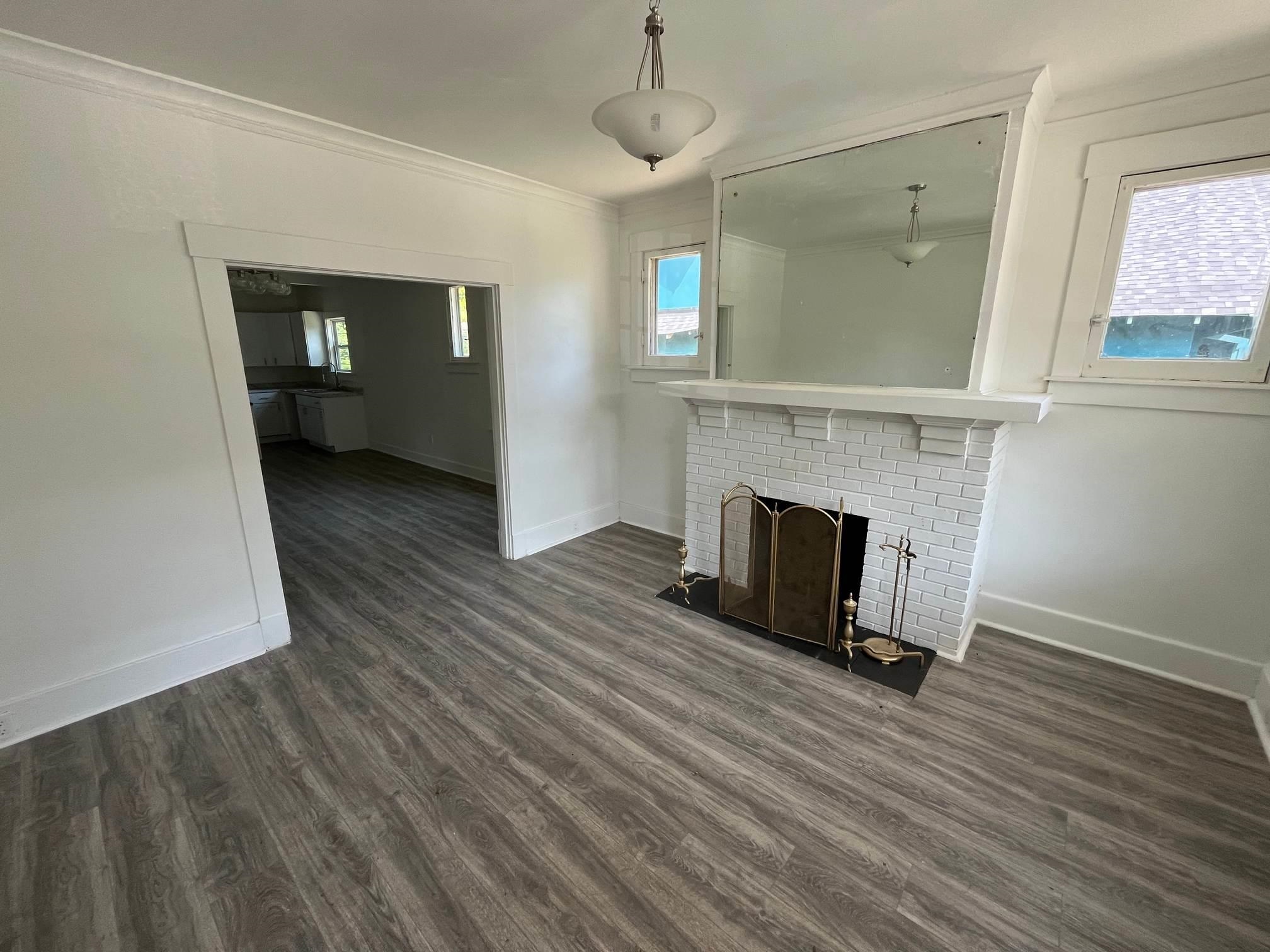 1131 Rozelle Street Memphis, TN 38106 - Photo 4 of 19 a view of a livingroom with wooden floor and a fireplace