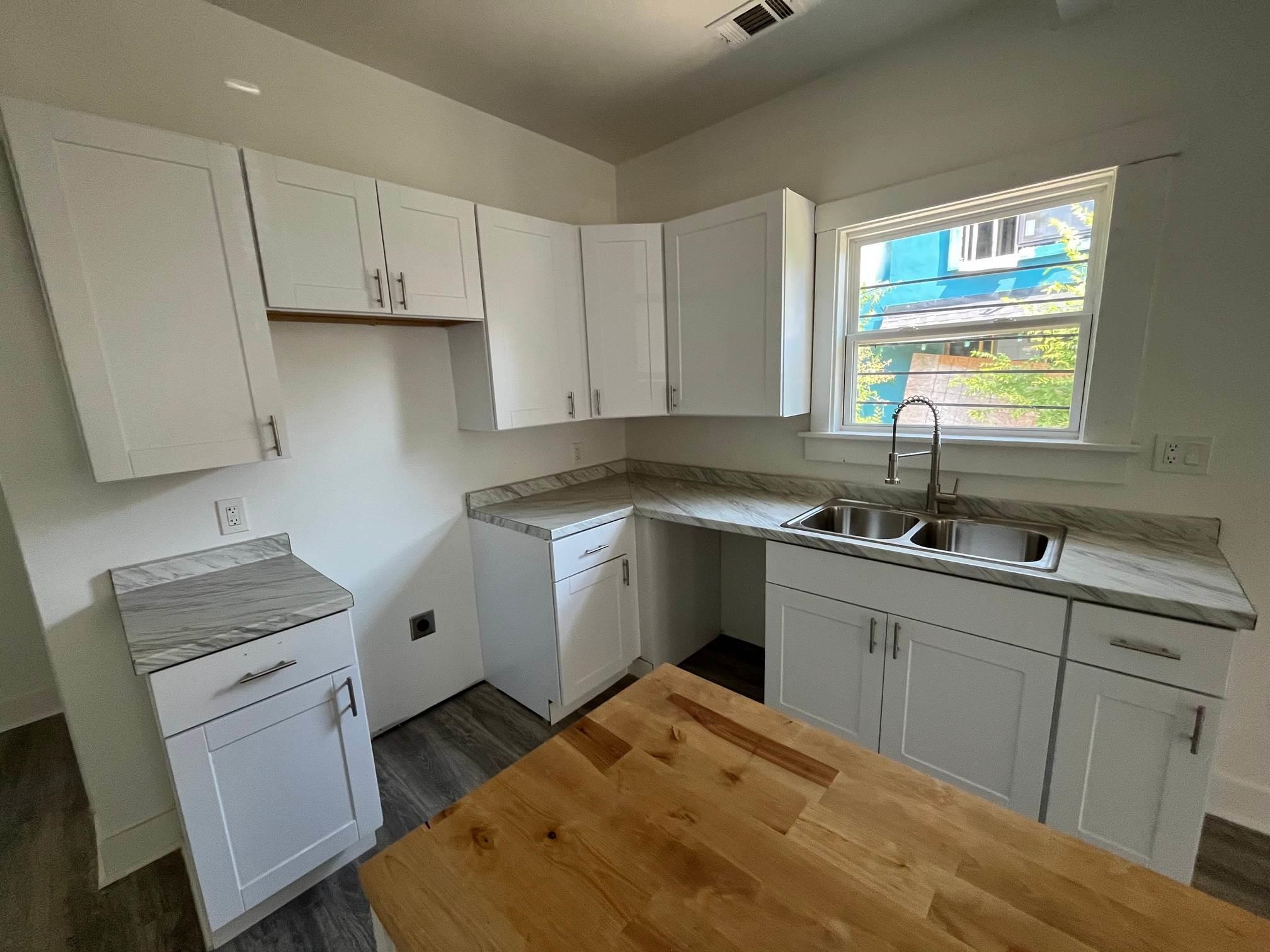 1131 Rozelle Street Memphis, TN 38106 - Photo 8 of 19 a kitchen that has a sink and a stove in it