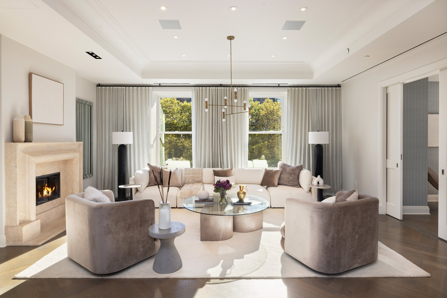 a living room with fireplace furniture and a large window