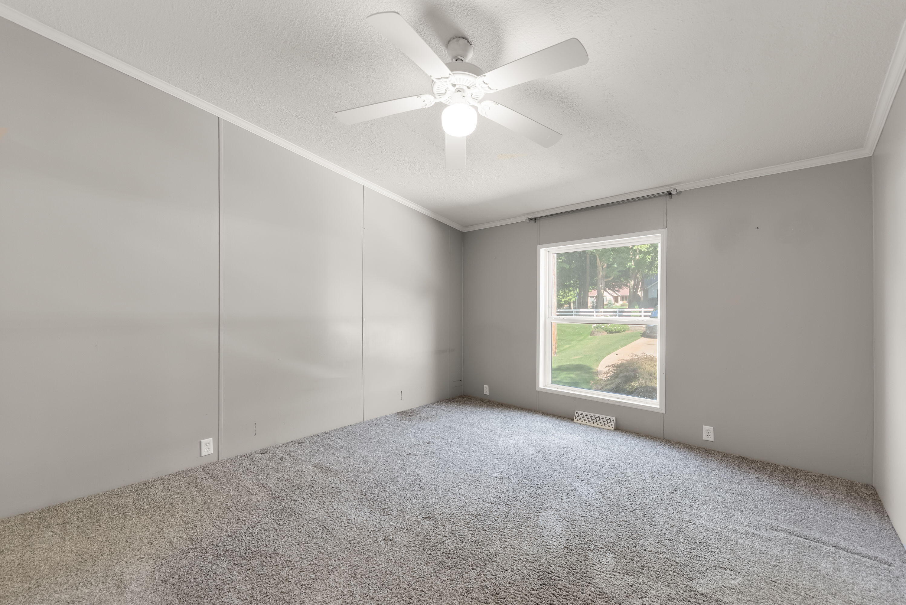 4678 West Schultz Road La Porte, IN 46350 - Photo 16 of 26 an empty room with windows and fan