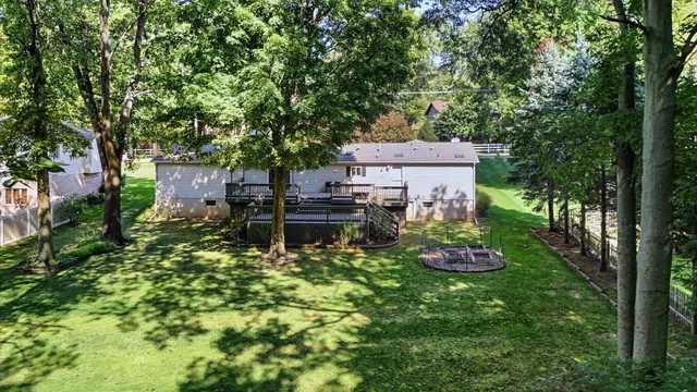 a backyard of a house with lots of green space and fountain view