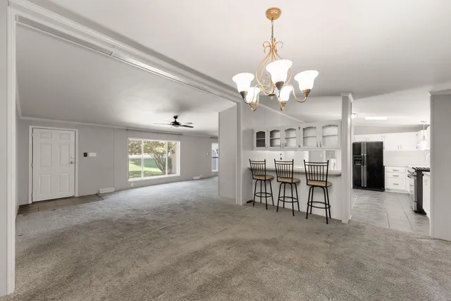 a view of a livingroom with furniture and a chandelier