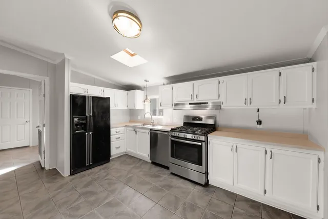 a kitchen with cabinets and steel stainless steel appliances