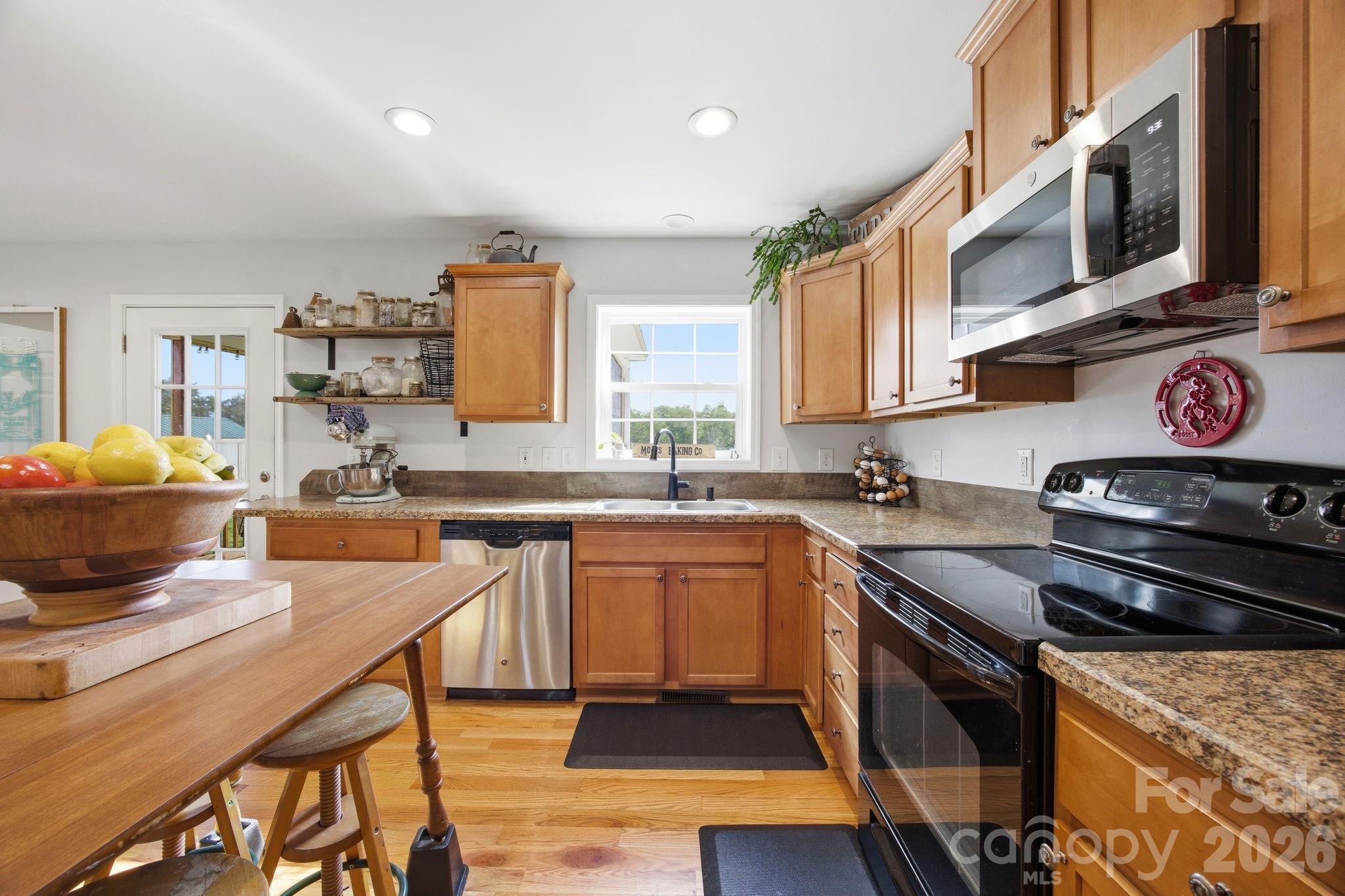 3480 Skyline Road Rock Hill, SC 29730 - Photo 13 of 40 a kitchen with stainless steel appliances granite countertop a stove a sink dishwasher and cabinets with wooden floor