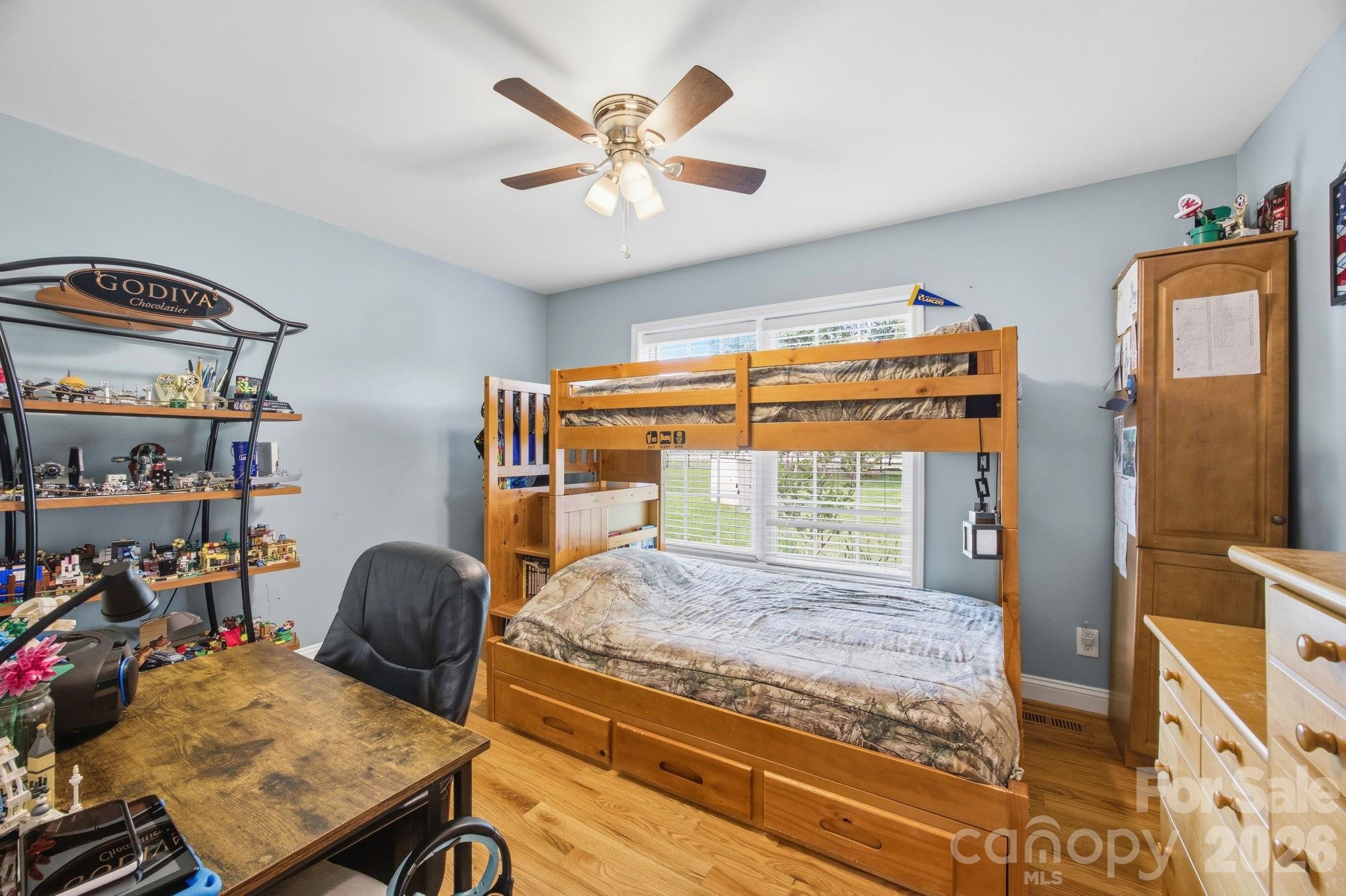 3480 Skyline Road Rock Hill, SC 29730 - Photo 21 of 40 a bedroom with a bed and a chandelier