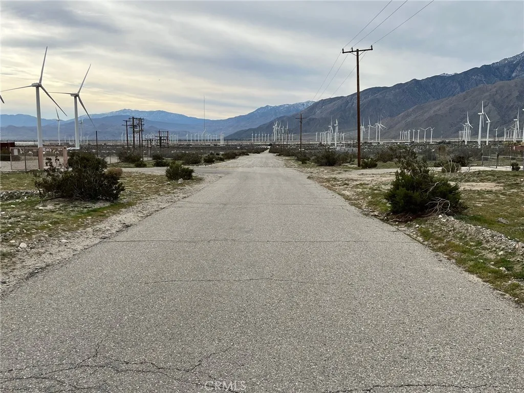 a view of a street with a pole on the road