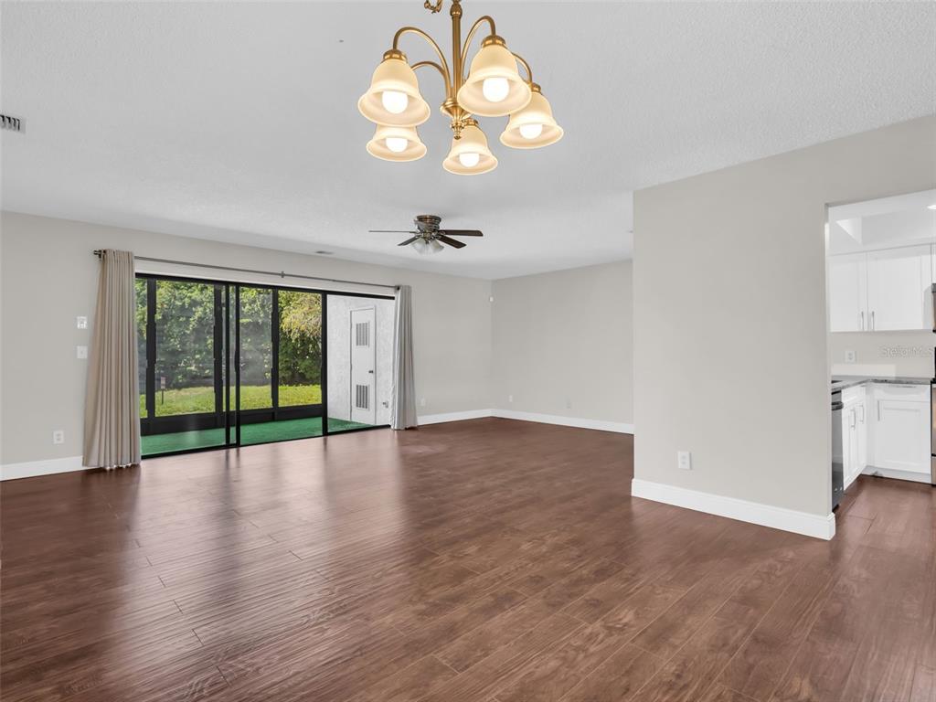 1801 East Lake Road South, Unit 20C Palm Harbor, FL 34685 - Photo 11 of 56 a view of an empty room with wooden floor and a window