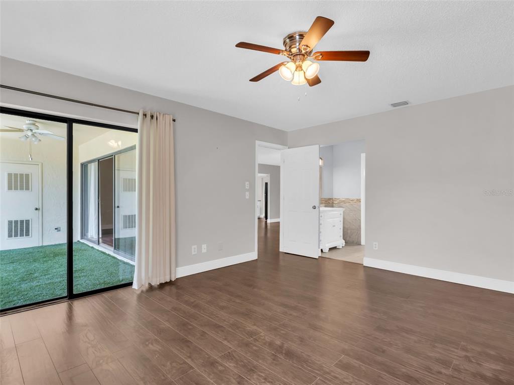 1801 East Lake Road South, Unit 20C Palm Harbor, FL 34685 - Photo 19 of 56 a view of an empty room with window and a ceiling fan