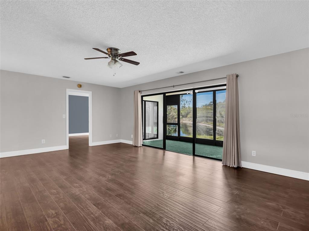 1801 East Lake Road South, Unit 20C Palm Harbor, FL 34685 - Photo 21 of 56 wooden floor in an empty room with a window