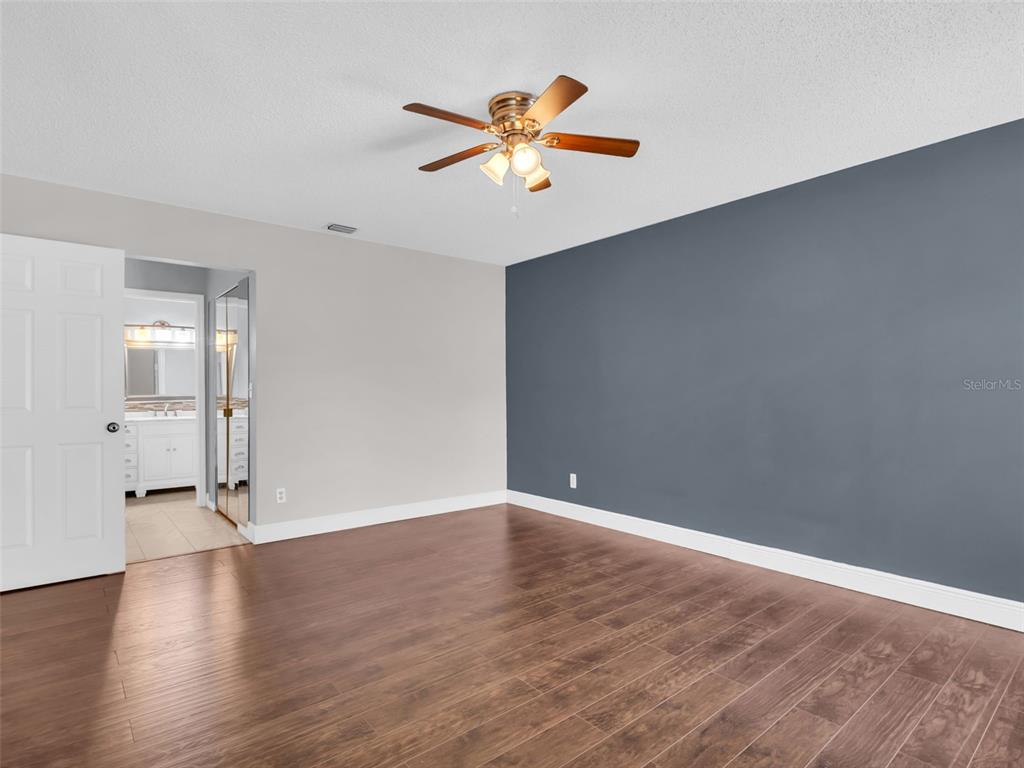 1801 East Lake Road South, Unit 20C Palm Harbor, FL 34685 - Photo 23 of 56 a view of an empty room with wooden floor