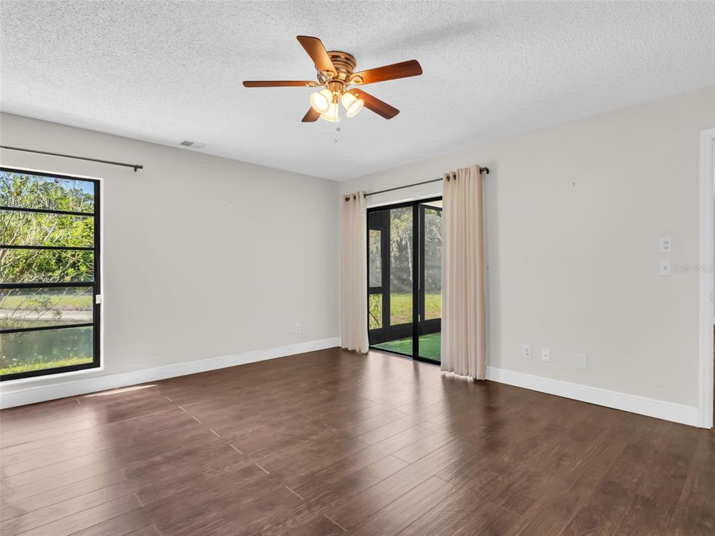 1801 East Lake Road South, Unit 20C Palm Harbor, FL 34685 - Photo 24 of 56 wooden floor in an empty room with a window