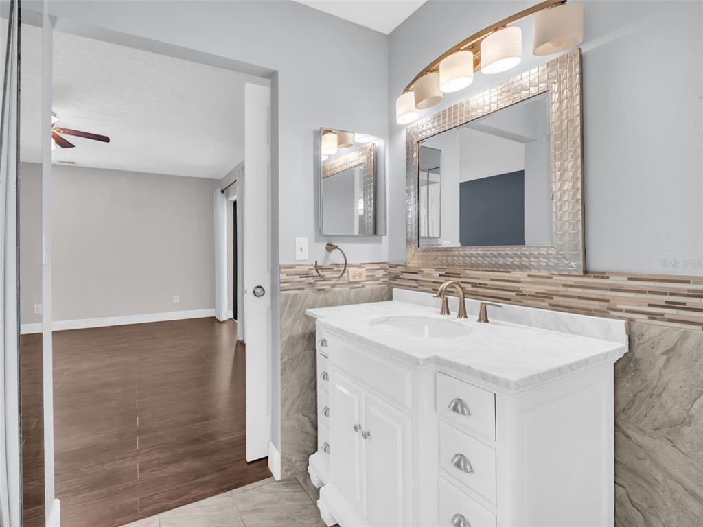 1801 East Lake Road South, Unit 20C Palm Harbor, FL 34685 - Photo 29 of 56 a bathroom with a sink and a mirror