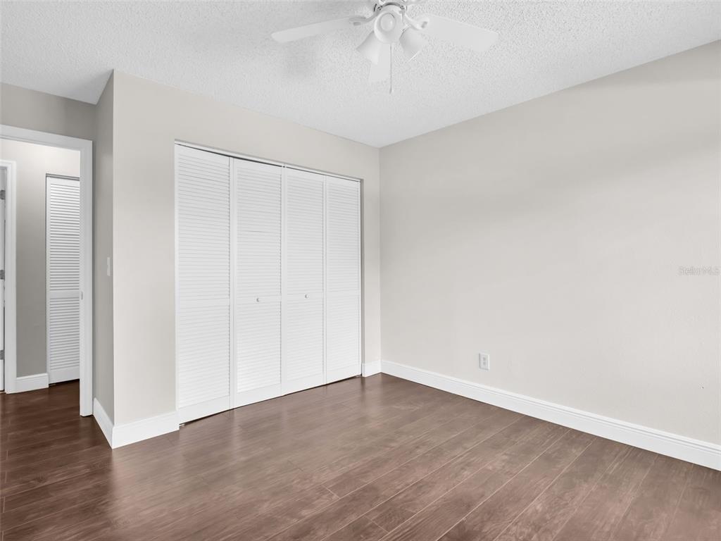 1801 East Lake Road South, Unit 20C Palm Harbor, FL 34685 - Photo 38 of 56 a view of an empty room with wooden floor