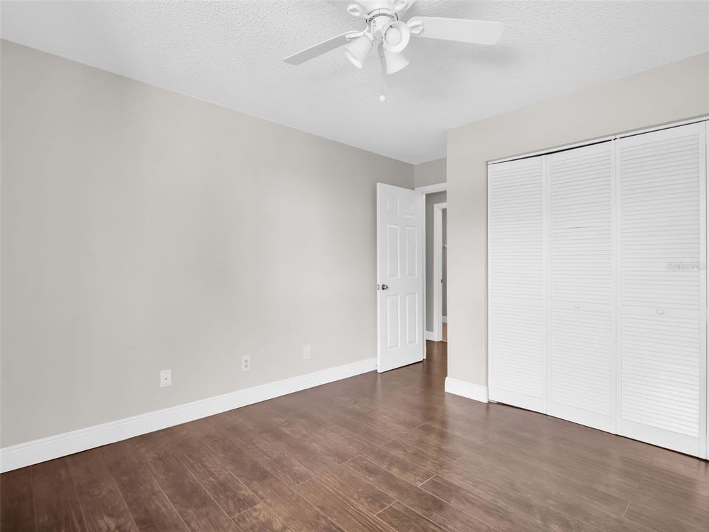 1801 East Lake Road South, Unit 20C Palm Harbor, FL 34685 - Photo 39 of 56 wooden floor in an empty room