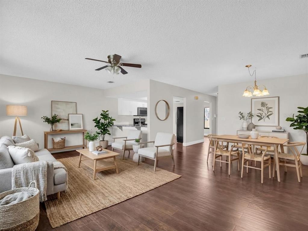1801 East Lake Road South, Unit 20C Palm Harbor, FL 34685 - Photo 4 of 56 a living room with furniture a rug and a chandelier