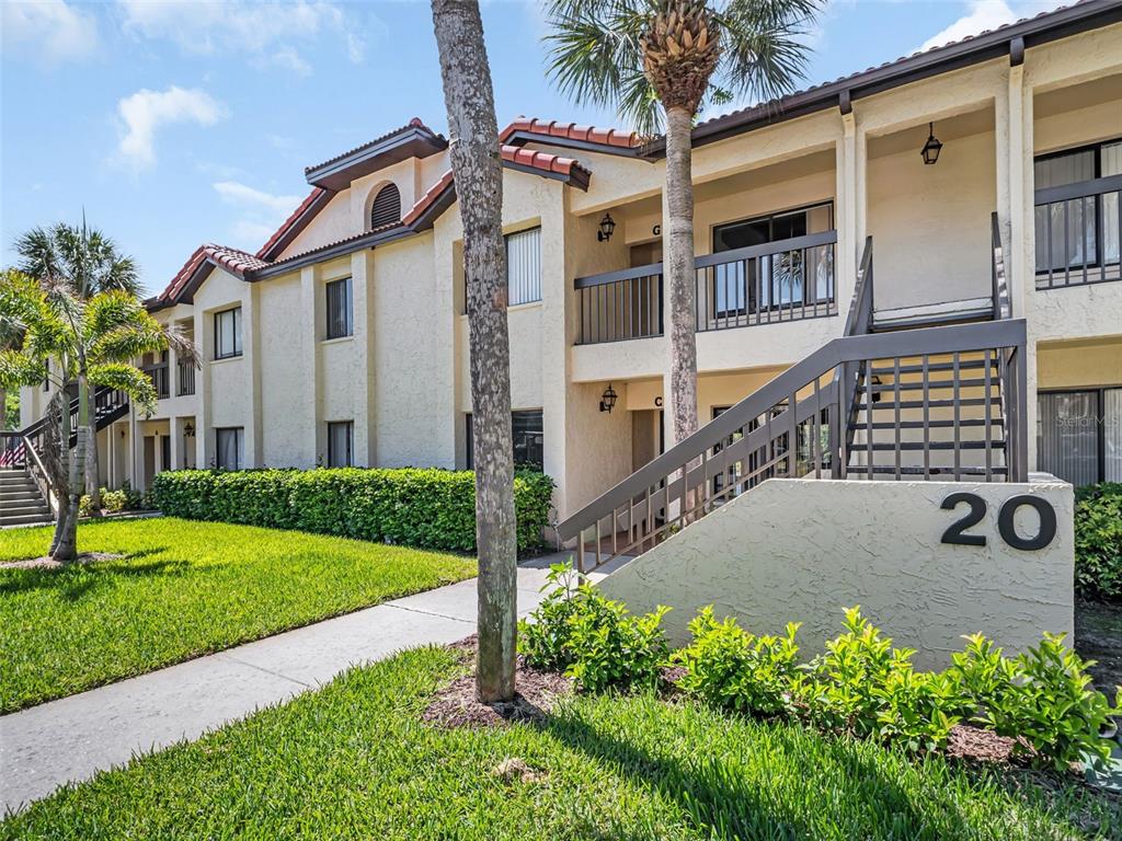 1801 East Lake Road South, Unit 20C Palm Harbor, FL 34685 - Photo 49 of 56 a front view of a house with garden