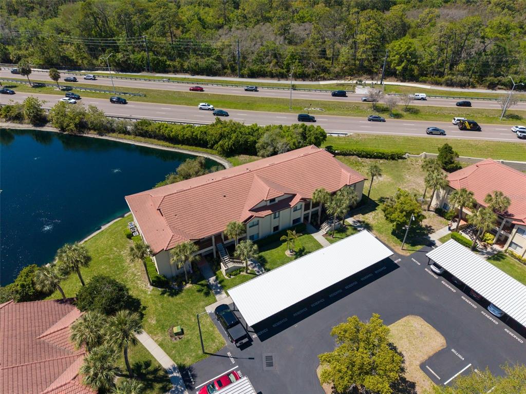1801 East Lake Road South, Unit 20C Palm Harbor, FL 34685 - Photo 55 of 56 an aerial view of a house with a lake view