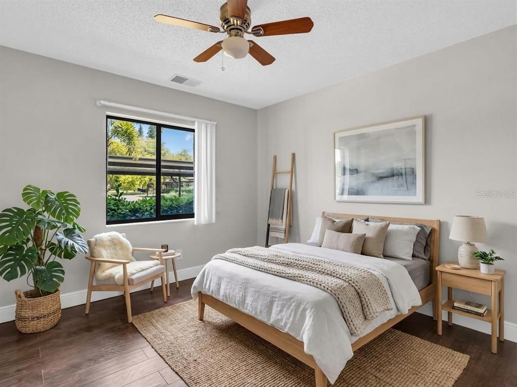 1801 East Lake Road South, Unit 20C Palm Harbor, FL 34685 - Photo 8 of 56 a bedroom with a large bed and a window