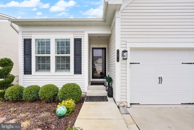 a kitchen with kitchen island granite countertop a sink and stainless steel appliances