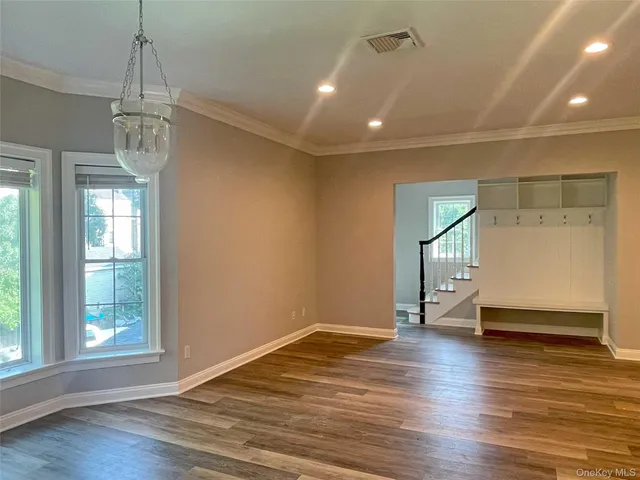 a kitchen with a sink and wooden floor