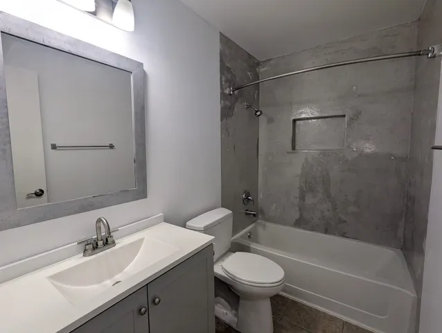 a bathroom with a sink mirror toilet and bathtub