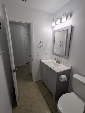 a bathroom with a sink toilet and mirror