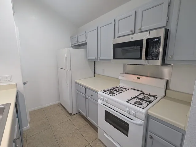 a kitchen with a stove and a microwave