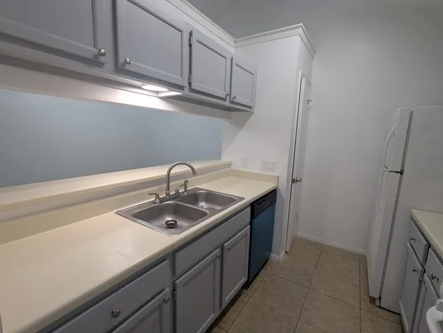 a view of a sink and dishwasher in a kitchen